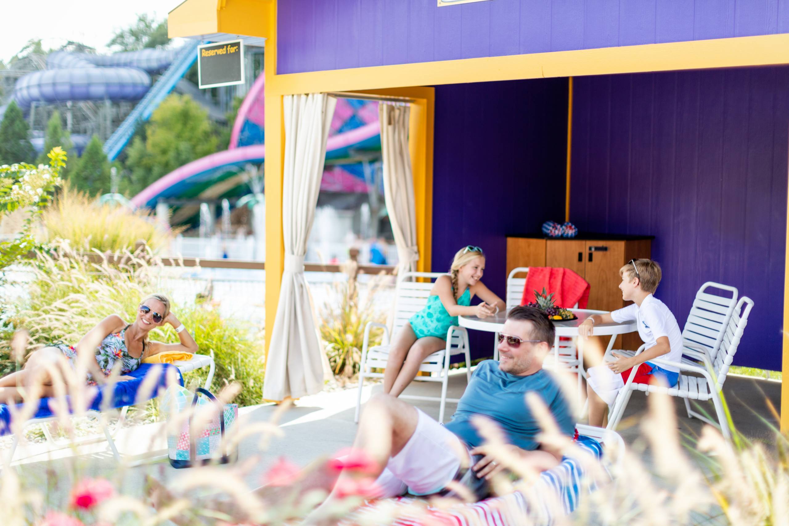 family relaxing in a Cabana in Splashin' Safari