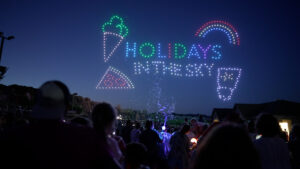 Drones spell out Holidays in the Sky logo