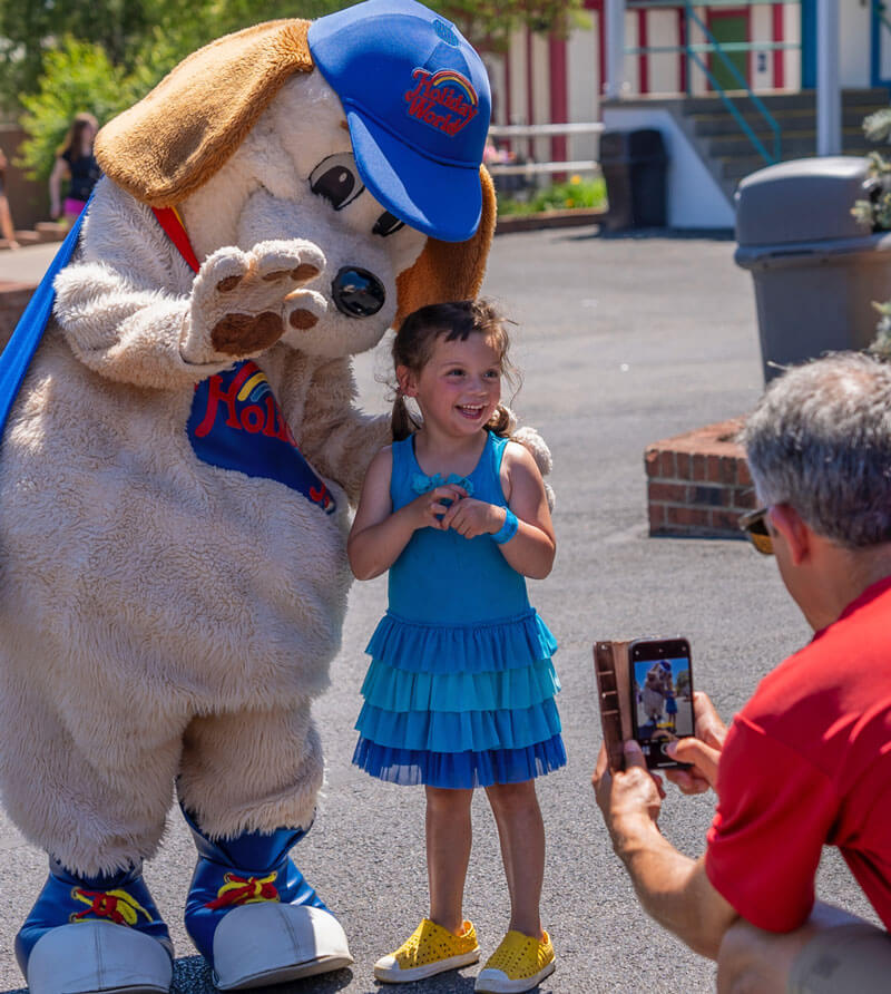 A child poses for a photo with Holidog