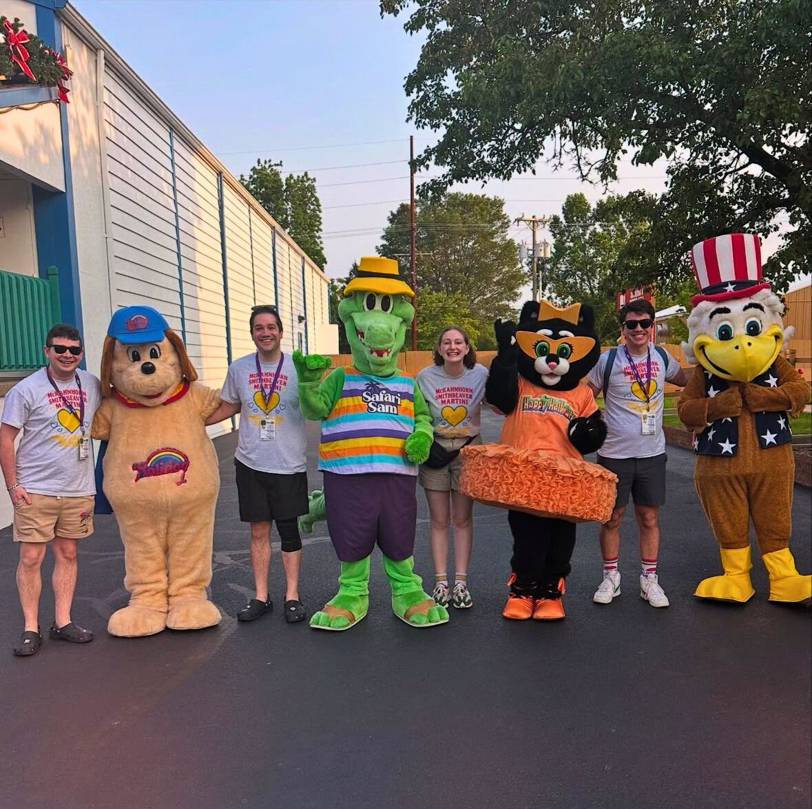 A group poses with Holidog, Safari Sam, Kitty Claws, and George the Eagle