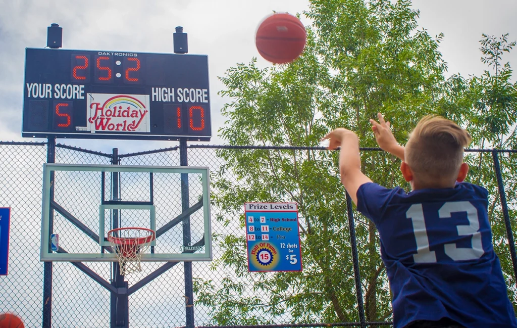 A player tests his skills at Three Point Challenge at Holiday World.