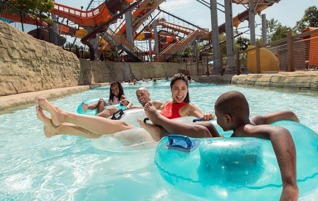A family smiles as they ride innertubes on Bahari River lazy river at Holiday World & Splashin' Safari in Santa Claus, Indiana.