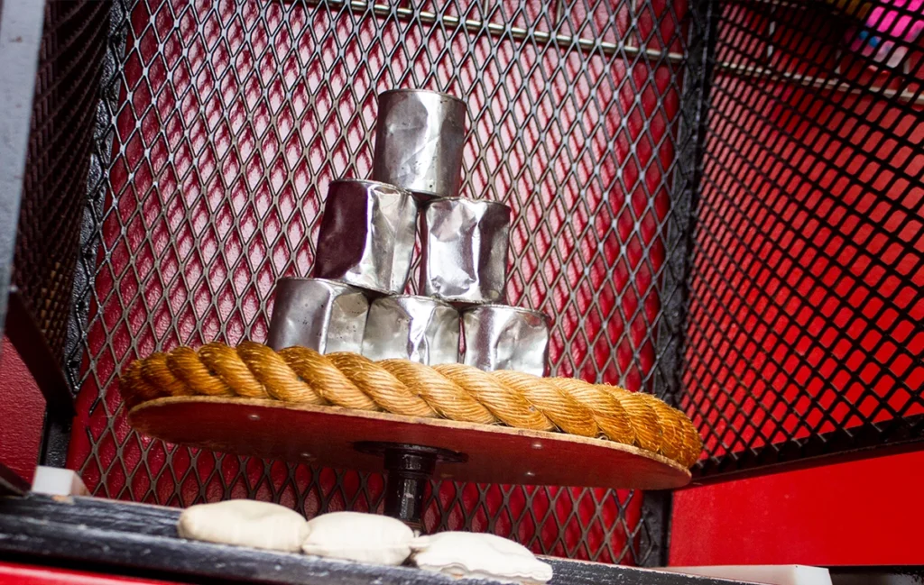 A pyramid of cans ready to be knocked over in Beanjamin's Bean Bag Toss at Holiday World.