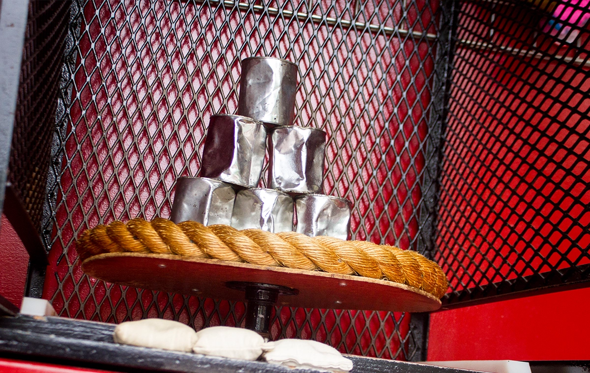 A pyramid of cans ready to be knocked over in Beanjamin's Bean Bag Toss at Holiday World.