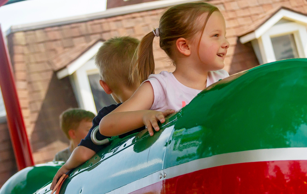Happy girl riding Comet's Rockets at Holiday World & Splashin' Safari in Santa Claus, Indiana.