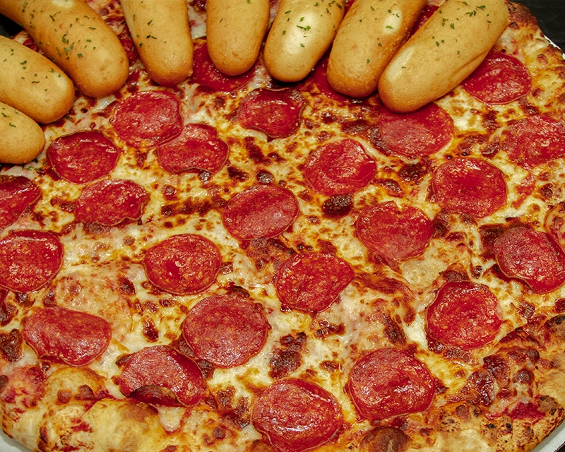 Family meal deal including a whole pizza plus eight breadsticks and four dipping sauces.