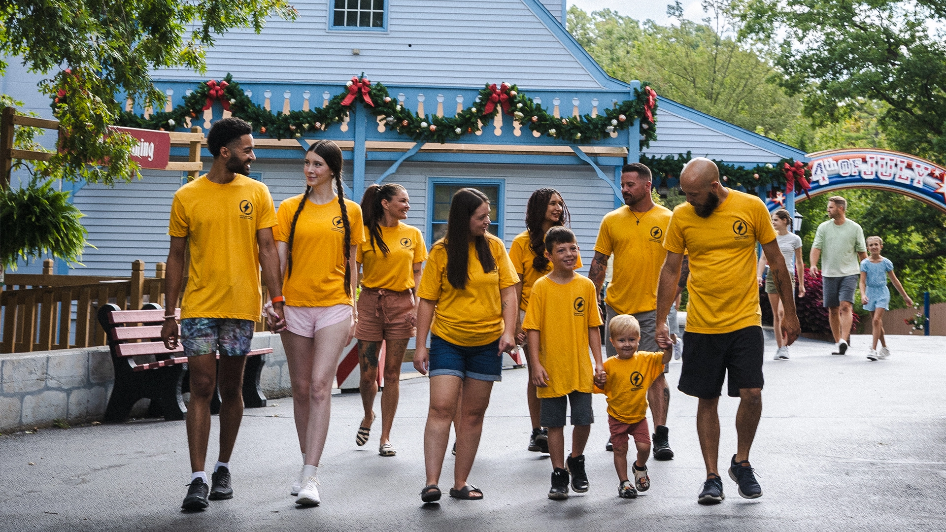 A corporate group in matching shirts walks through Holiday World.