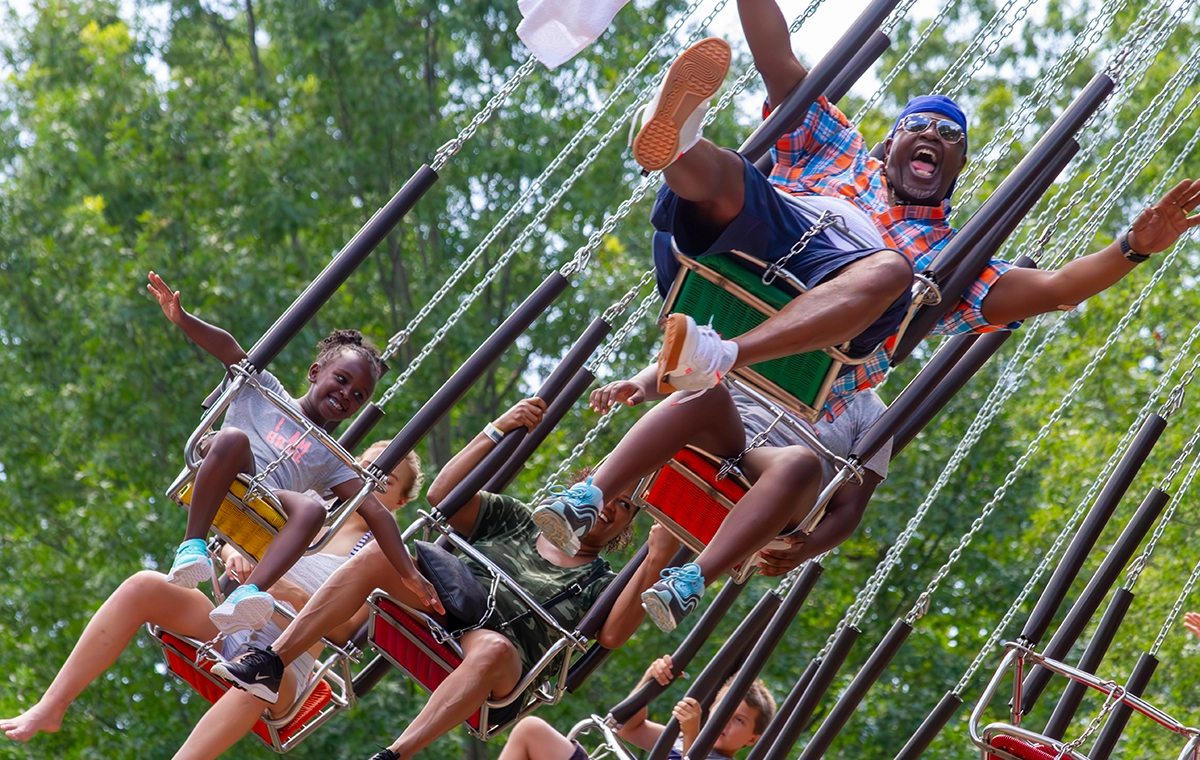 A fun dad hamming it up on HallowSwings at Holiday World & Splashin' Safari in Santa Claus, Indiana.