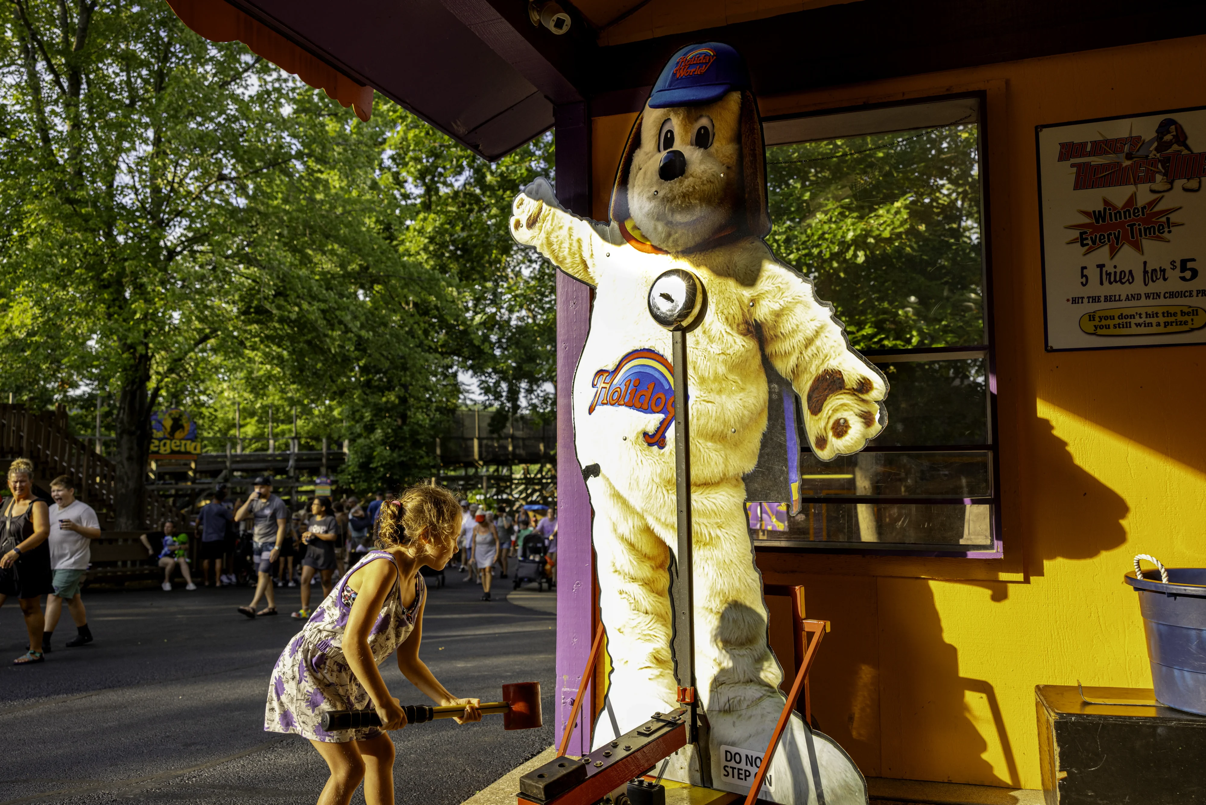 A little girl trying her strength at Holidog's Hammertime.