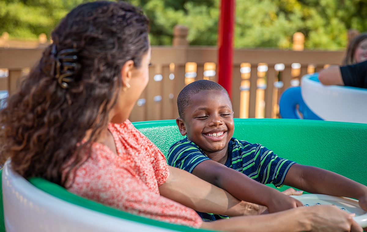 A mother and son are ready to spin on Kitty's Tea Party at Holiday World & Splashin' Safari in Santa Claus, Indiana.
