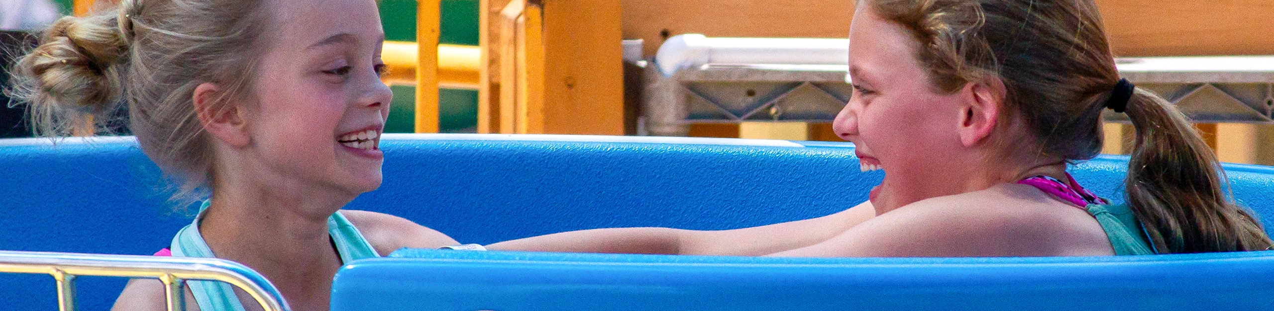 Two girls trying to spin as fast as they can on Kitty's Tea Party at Holiday World & Splashin' Safari in Santa Claus, Indiana.