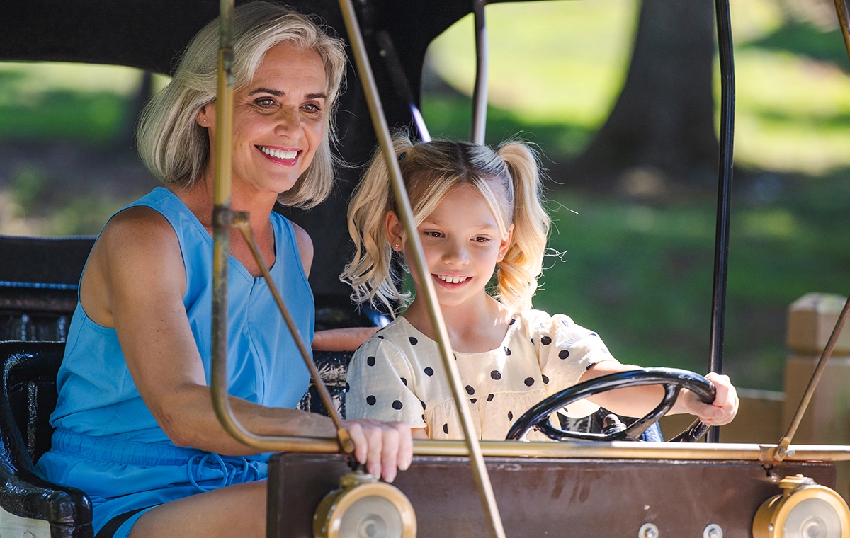 A grandmother and grand daughter ride together on Lewis & Clark Trail at Holiday World & Splashin' Safari in Santa Claus, Indiana.