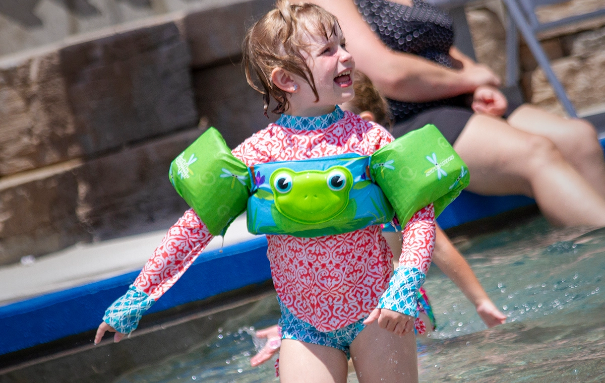 A young girl smiles as she plays in Tembo Tides at Holiday World & Splashin' Safari in Santa Claus, Indiana.