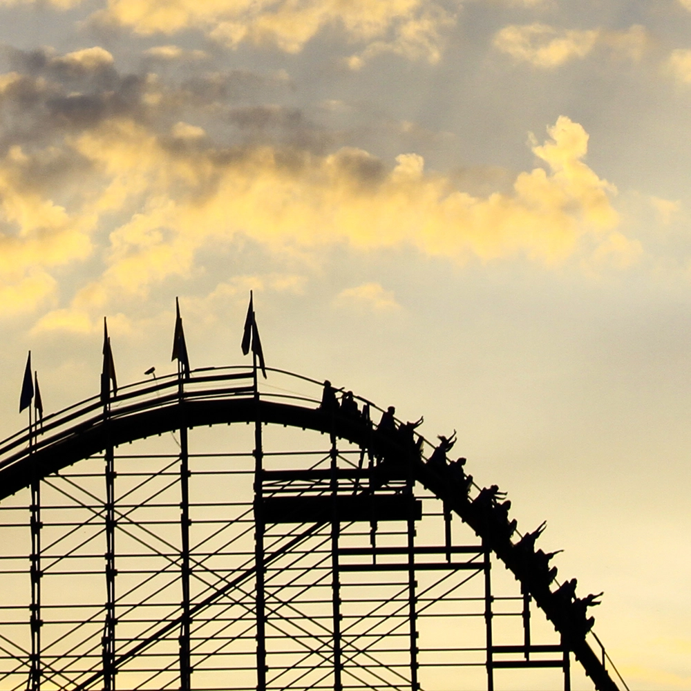 A train crests the first drop of The Voyage Wooden Roller Coaster as it is silhouetted against the sky at Holiday World & Splashin' Safari in Santa Claus, Indiana