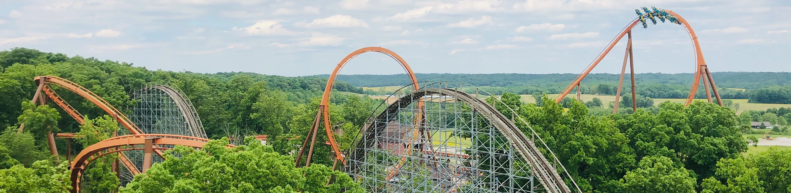 Aerial view of Thunderbird Wing Coaster soaring above the trees at Holiday World & Splashin' Safari in Santa Claus, Indiana.