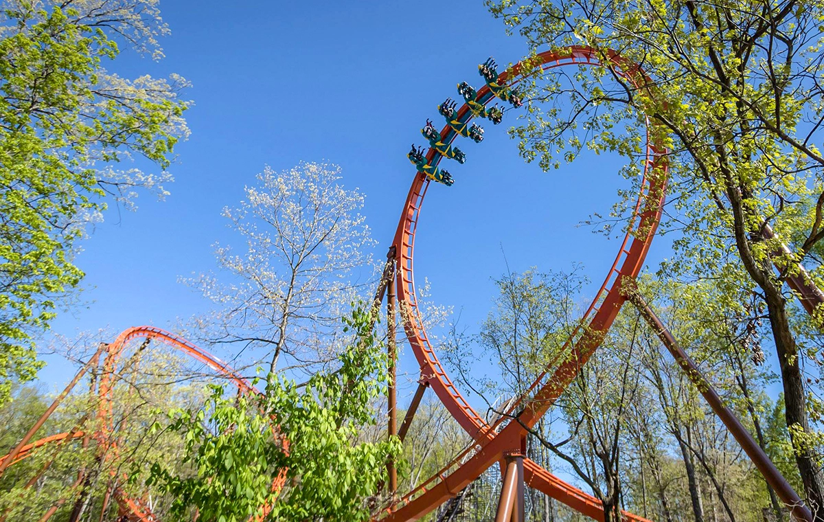 Looking up through the trees as Thunderbird Wing Coaster travels through the vertical loop at Holiday World & Splashin' Safari in Santa Claus, Indiana.