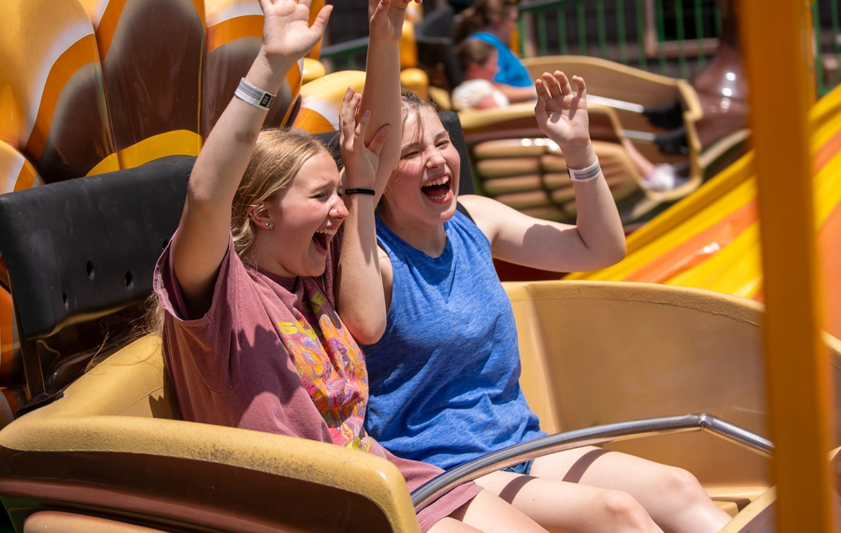 Two teenage girls laugh as they spin on Turkey Whirl at Holiday World & Splashin' Safari in Santa Claus, Indiana.