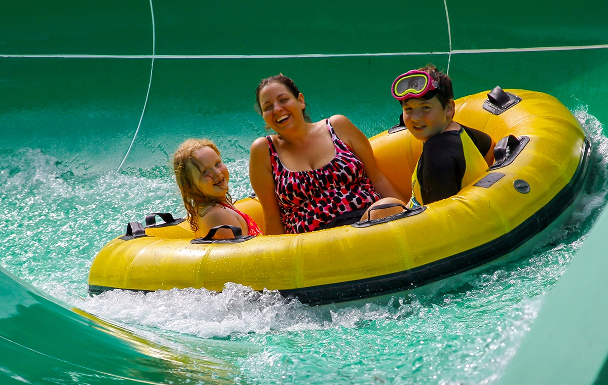 A mom and her young son and daughter slide down Watubee at Holiday World & Splashin' Safari in Santa Claus, Indiana.