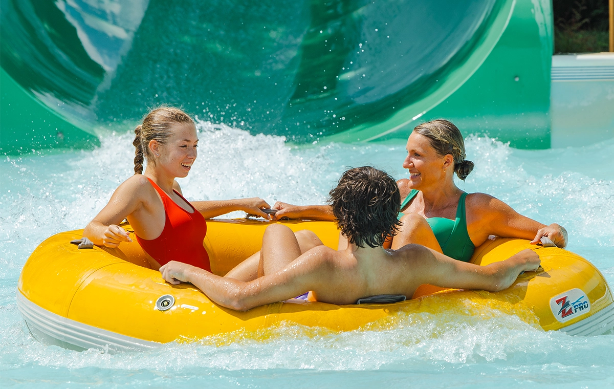 Mom and her teenage son and daughter in the splash pool of Watubee at Holiday World & Splashin' Safari in Santa Claus, Indiana.