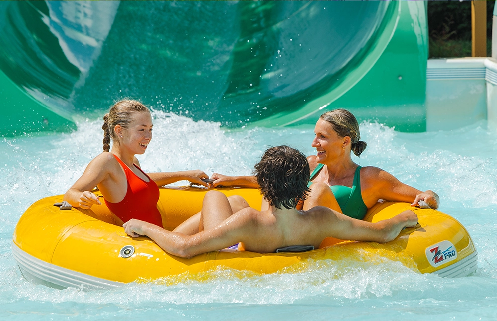Mom and her teenage son and daughter in the splash pool of Watubee at Holiday World & Splashin' Safari in Santa Claus, Indiana.